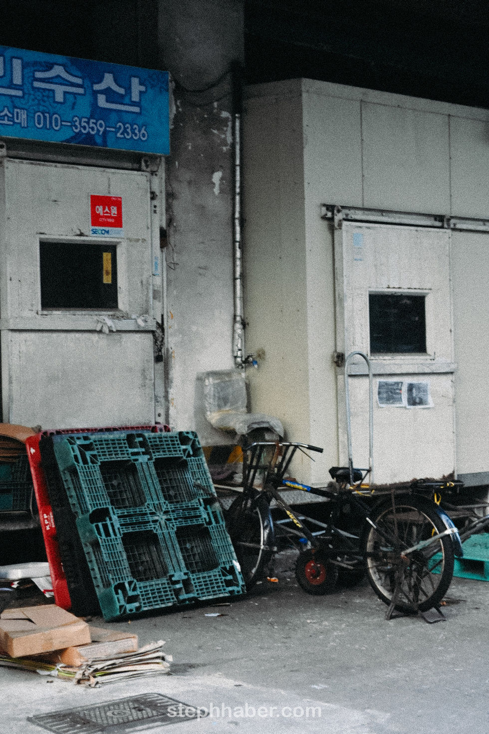 Urban scene with bicycle and industrial doors.