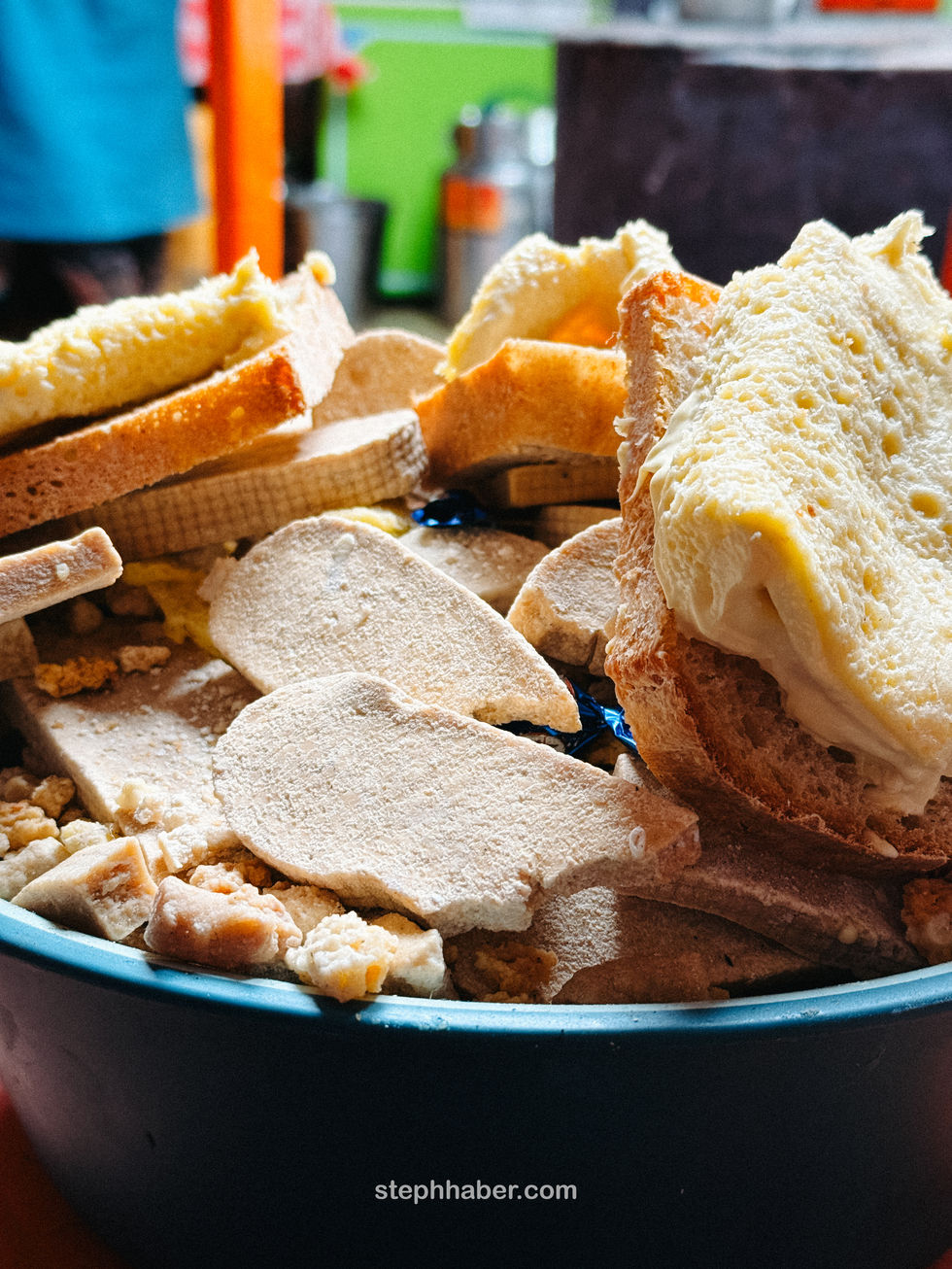 Assorted breads and crackers in a blue bowl.