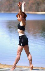 Founder of Brain Waves Yoga, Jacqui Driscoll, practicing yoga by lake