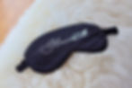 black sleep mask with silver writing