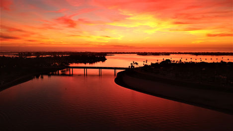 Drone photography of the Sun setting behind the Ingraham St. Bridge, San Diego CA