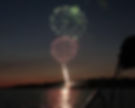 Fireworks over the lake at sunset.
