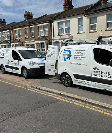 Professional window cleaner using equipment on a residential property in Rayleigh.