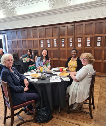 picture of people around a table attending one of Barbara Rowe's talks