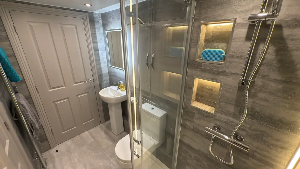 Sleek bathroom interior with glass shower screen and backlit mirror at 11a Park Road.