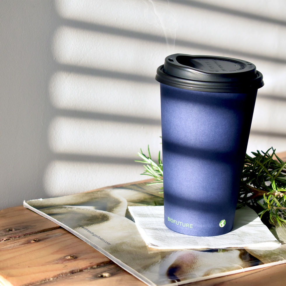 Blue paper cup on a coffee table with steam rising from the lid
