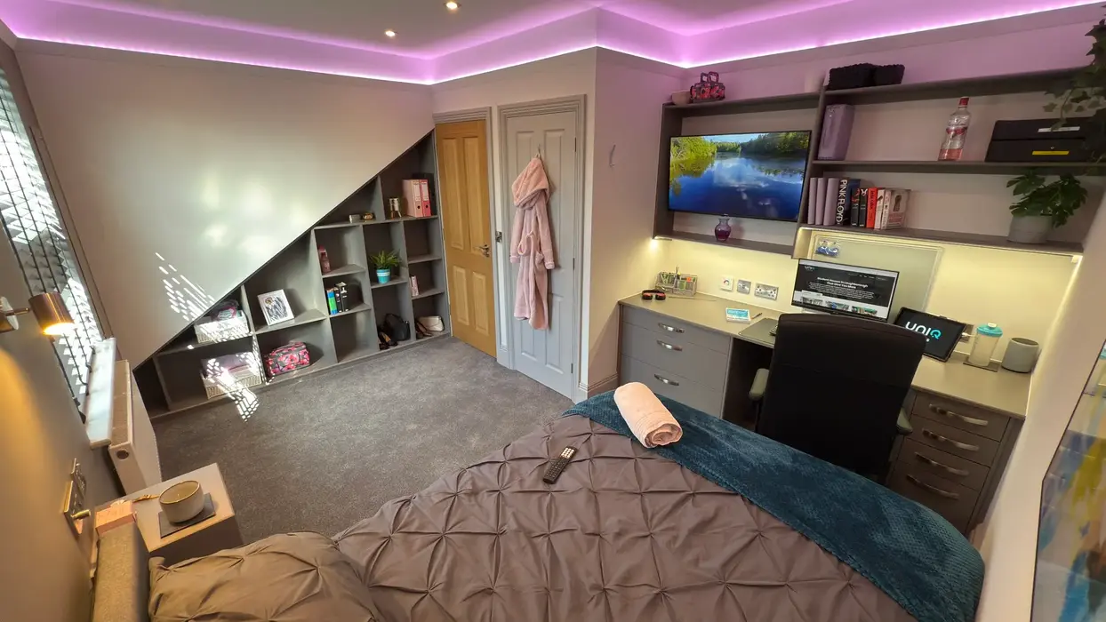 Comfortable bedroom designed for Loughborough students with modern lighting and sleek furnishings
