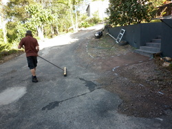 Old cracked asphalt driveway before repair and crack sealing