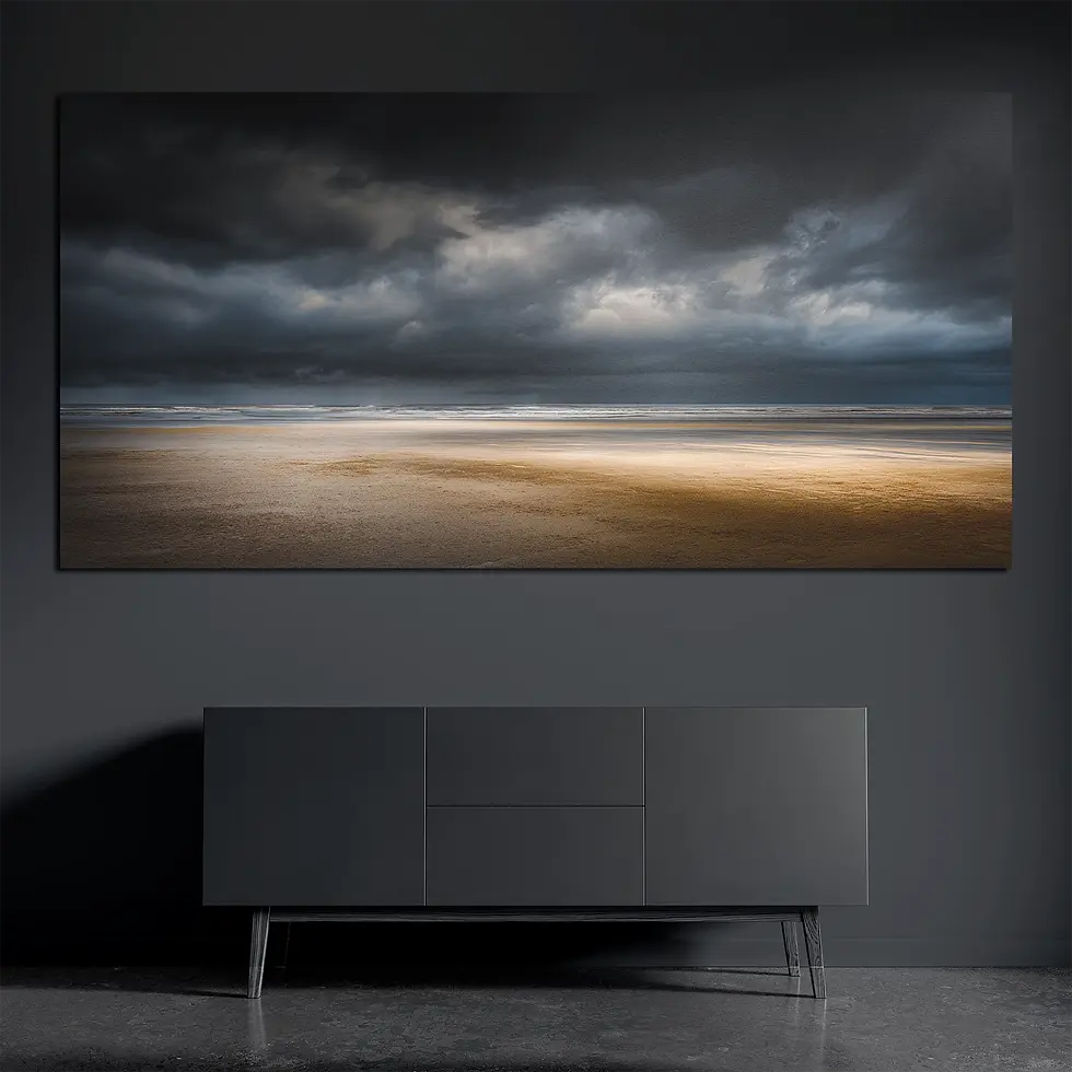 Panoramic brushed aluminum wall art showing dramatic storm clouds over empty beach