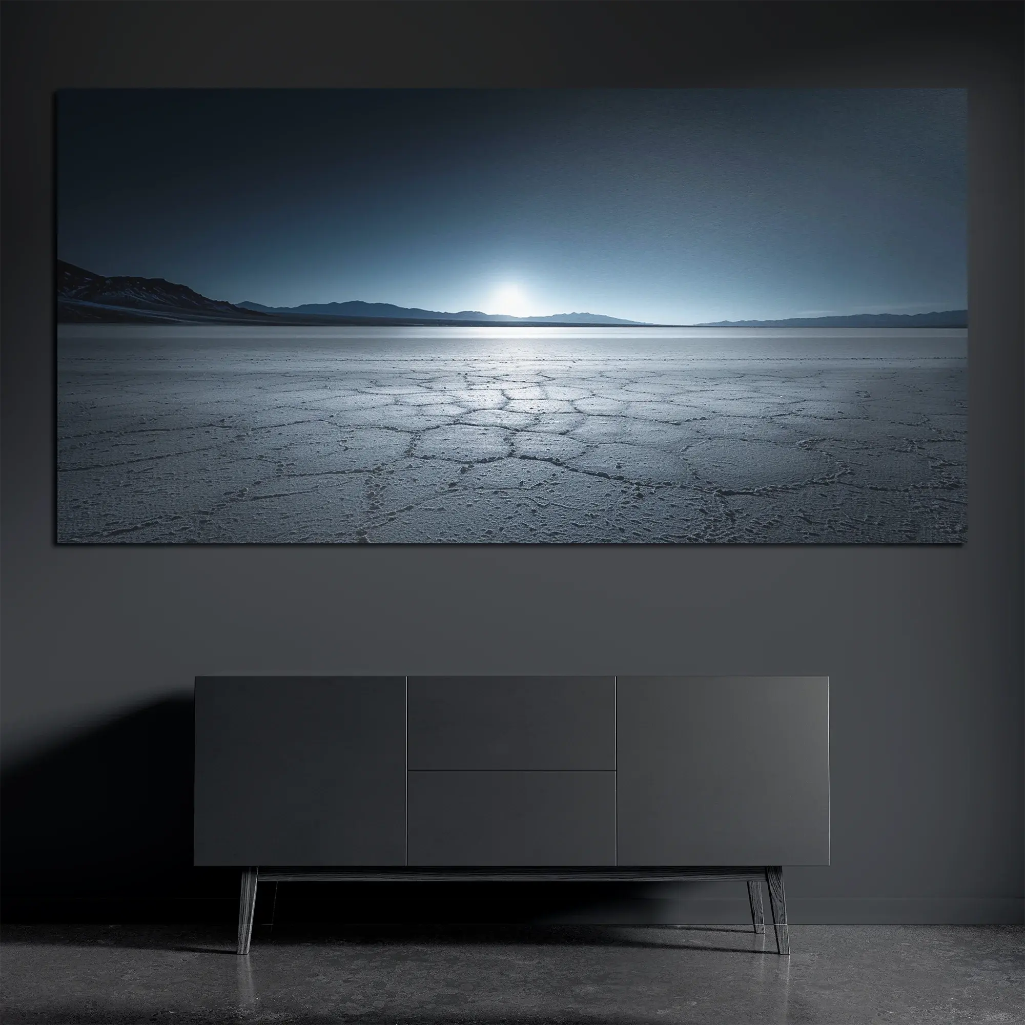 Panoramic brushed aluminum salt flats wall art on dark wall above dark console
