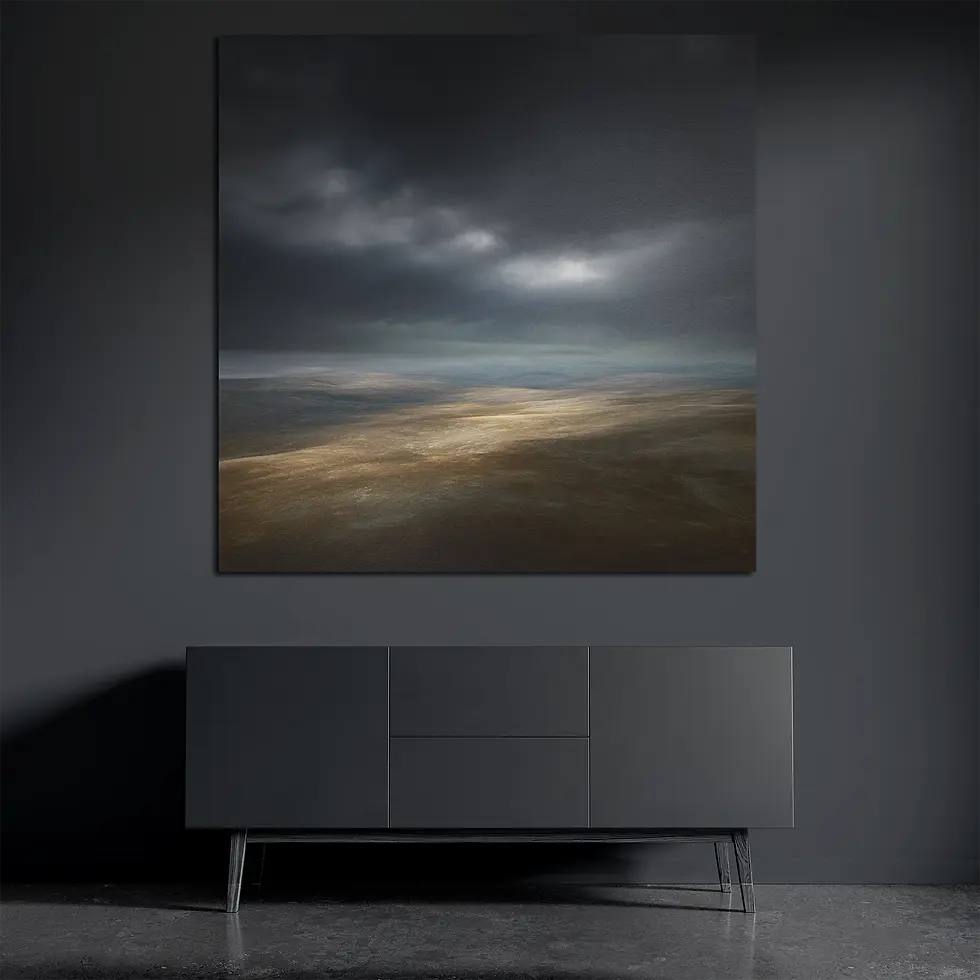 Square metal wall art above dark console with dramatic storm sky