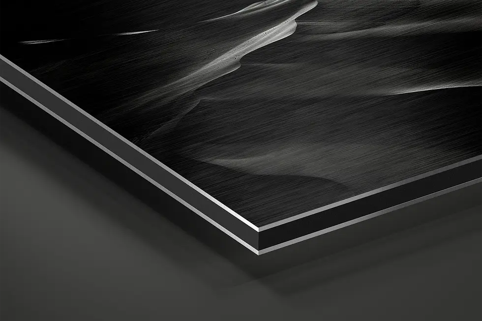 Thumbnail: Close-up of brushed aluminum surface with sculptural black sand detail