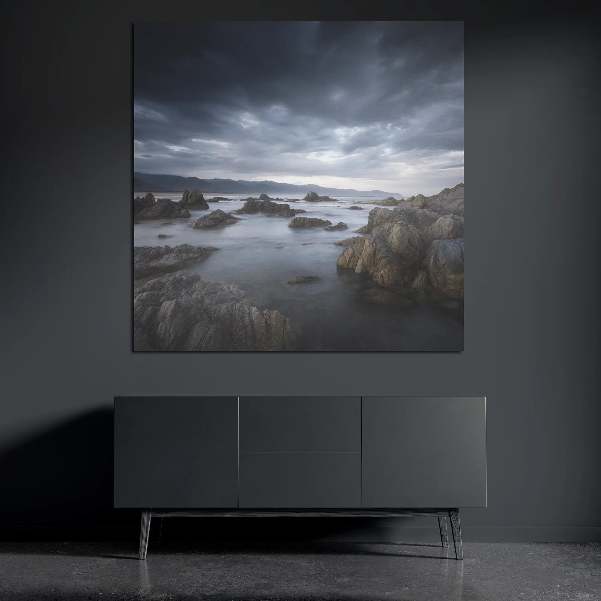 Stormy coastal metal wall art on brushed aluminum above dark console