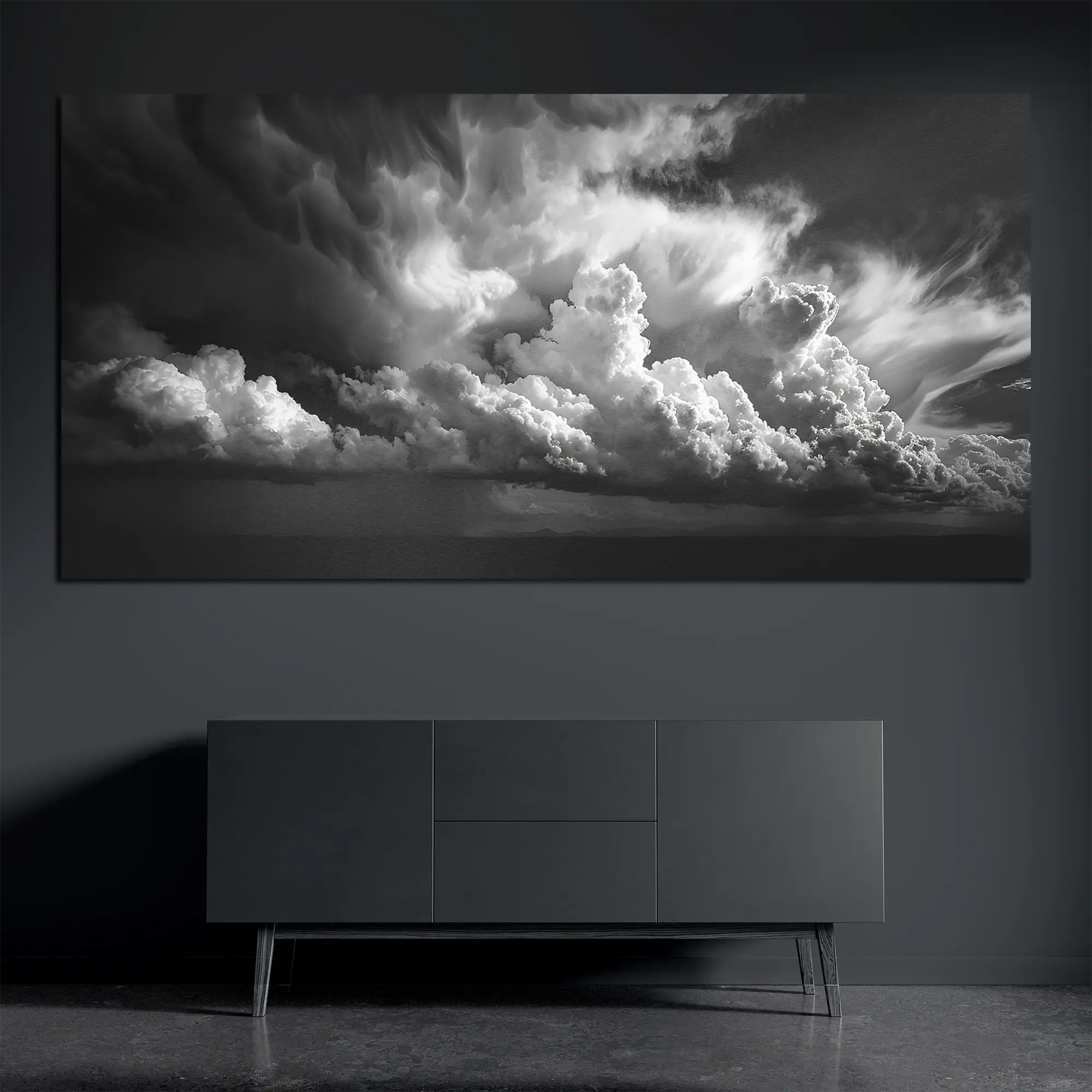 Black and white storm cloud metal wall art on brushed aluminum above dark console