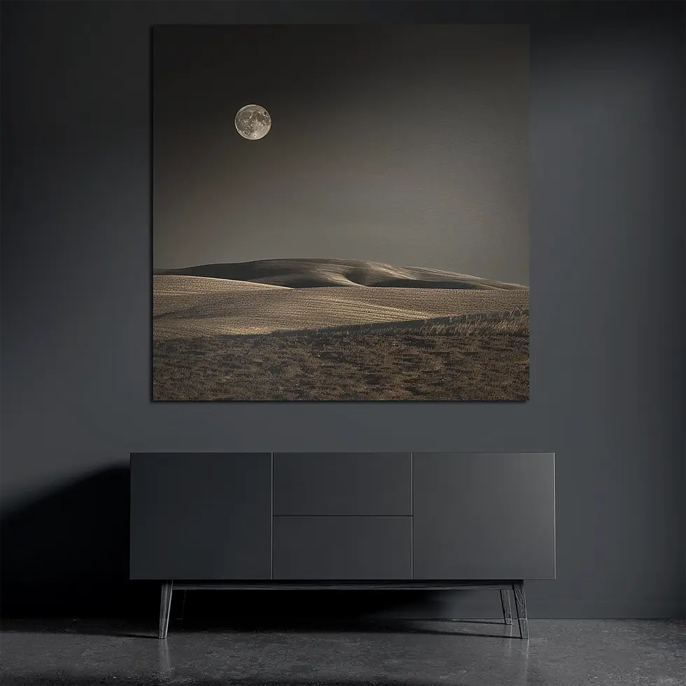 Square metal wall art above dark console with full moon desert scene