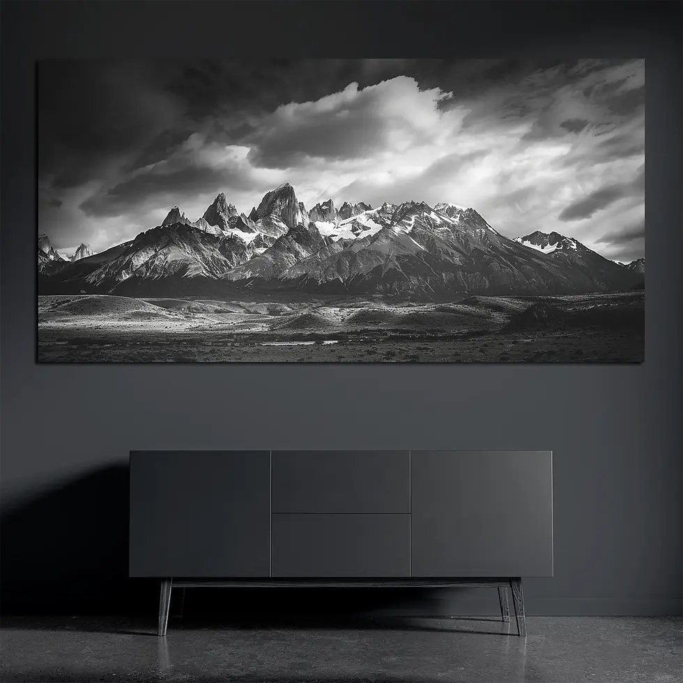 Panoramic brushed aluminum wall art with dramatic mountain peaks on dark wall above dark console