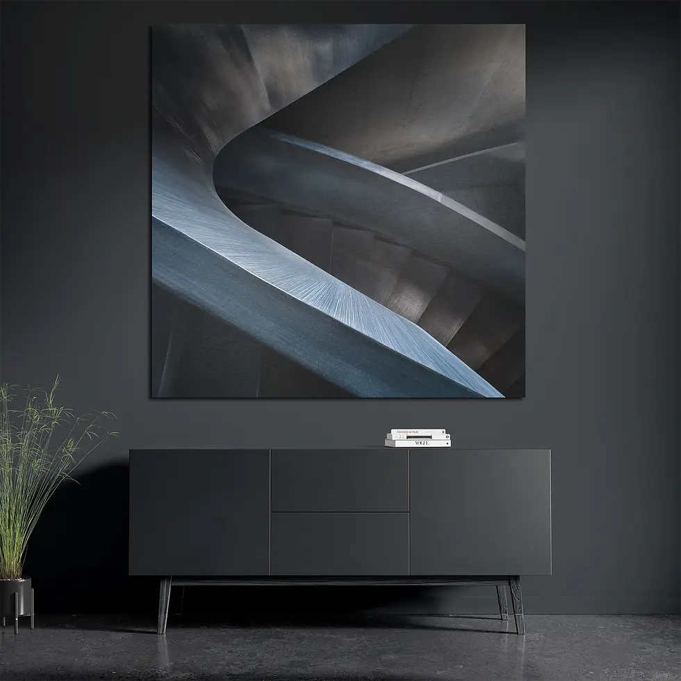 Square brushed aluminum wall art above dark console styled with books and plant