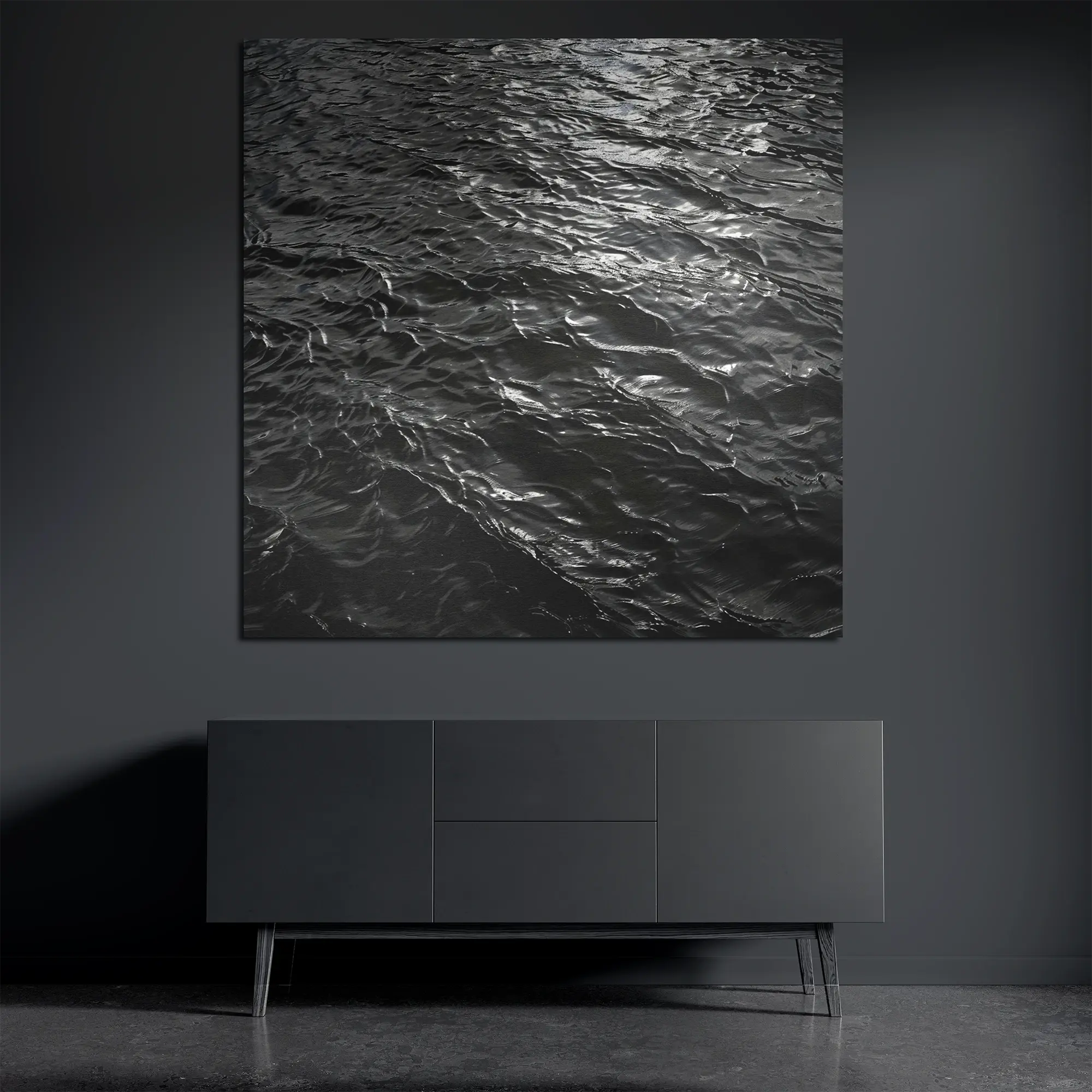 Dark water metal wall art on brushed aluminum above dark console