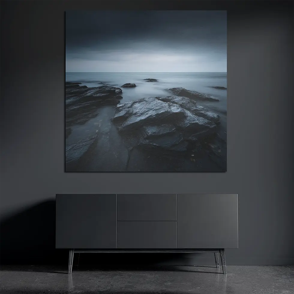 Square metal wall art above dark console with moody coastal rocks