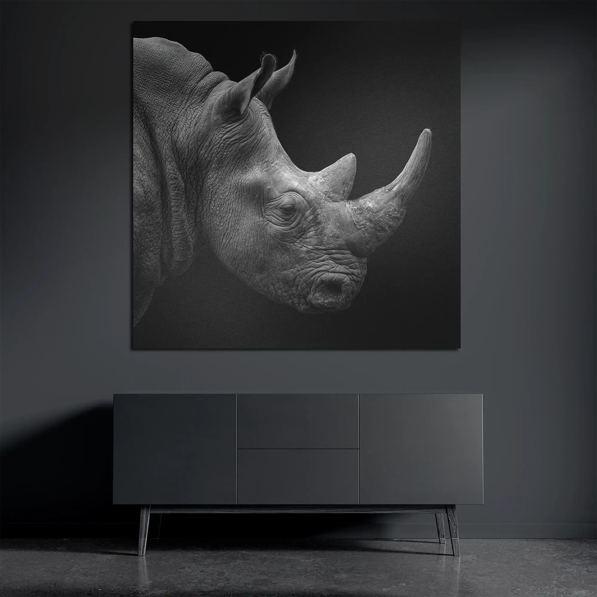 Square brushed aluminum wall art with minimalist rhinoceros portrait in dark interior