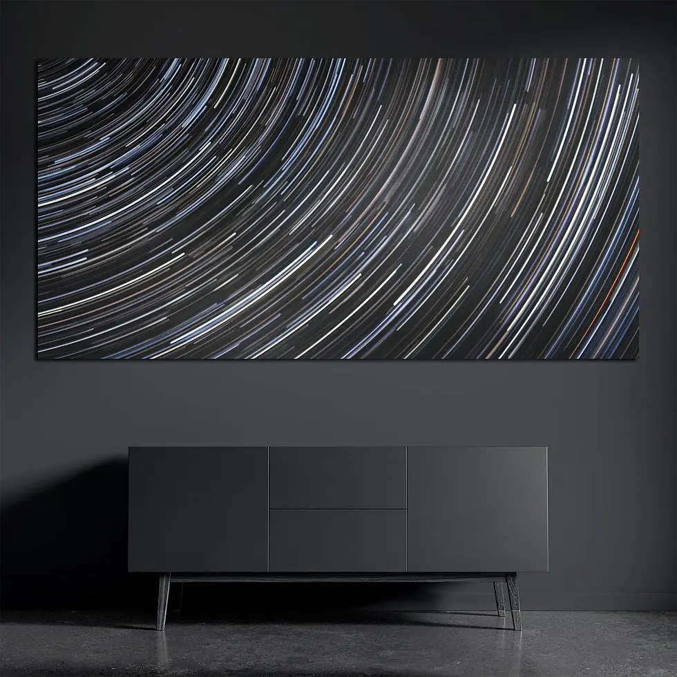 Star trails metal wall art on brushed aluminum above dark console