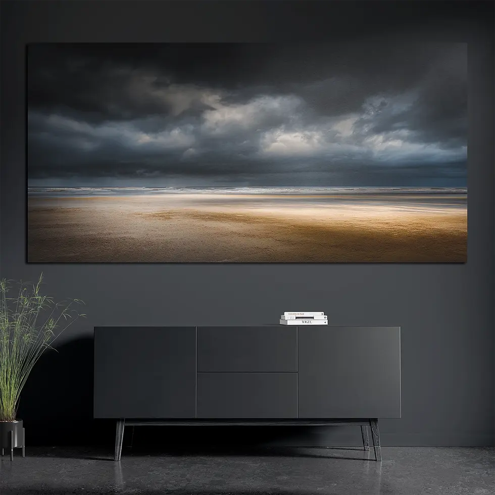 Brushed aluminum metal wall art with stormy shoreline above dark console with books