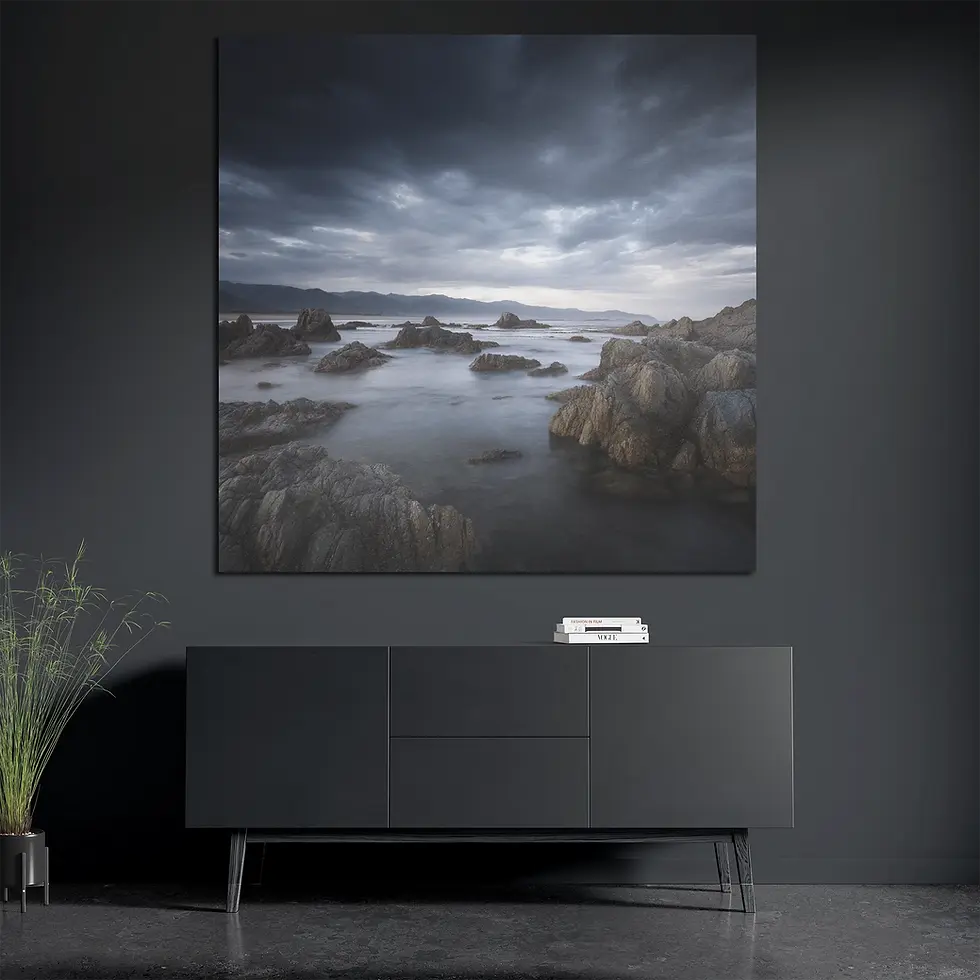 Square seascape print styled with books and plant in modern interior