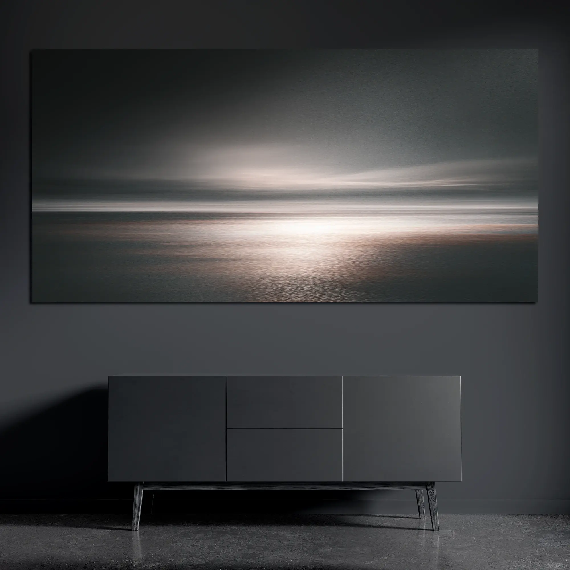 Panoramic brushed aluminum wall art with soft ocean horizon on dark wall above dark console
