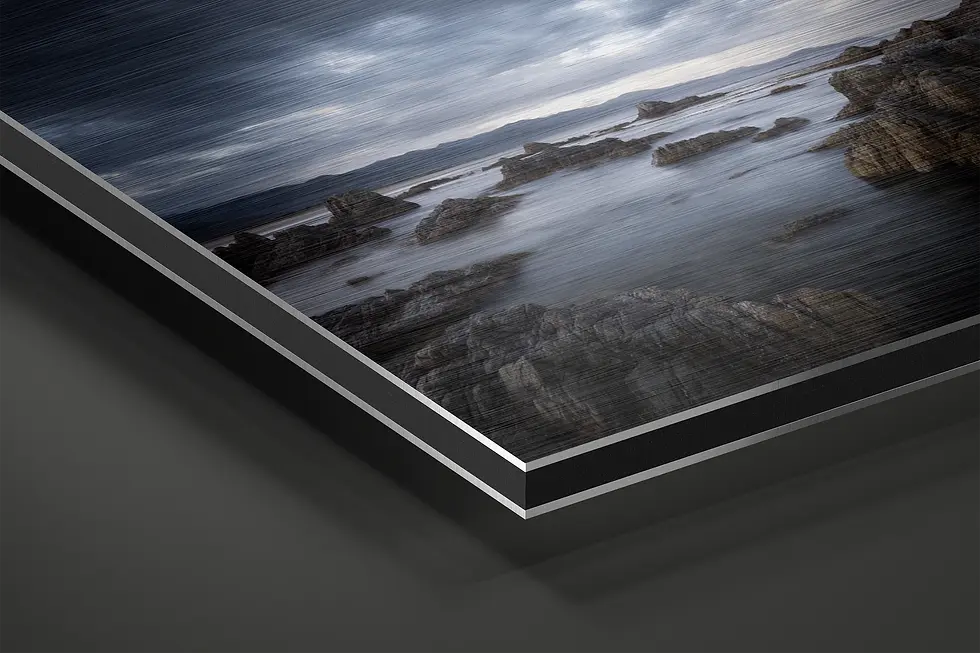 Thumbnail: Close-up of brushed aluminum texture with rocky shoreline and soft water detail