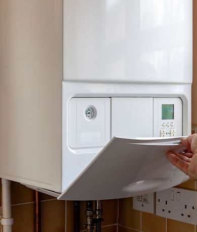Cost of Living Crisis Concept_ Hand of Caucasian man opens gas boiler control panel to tur