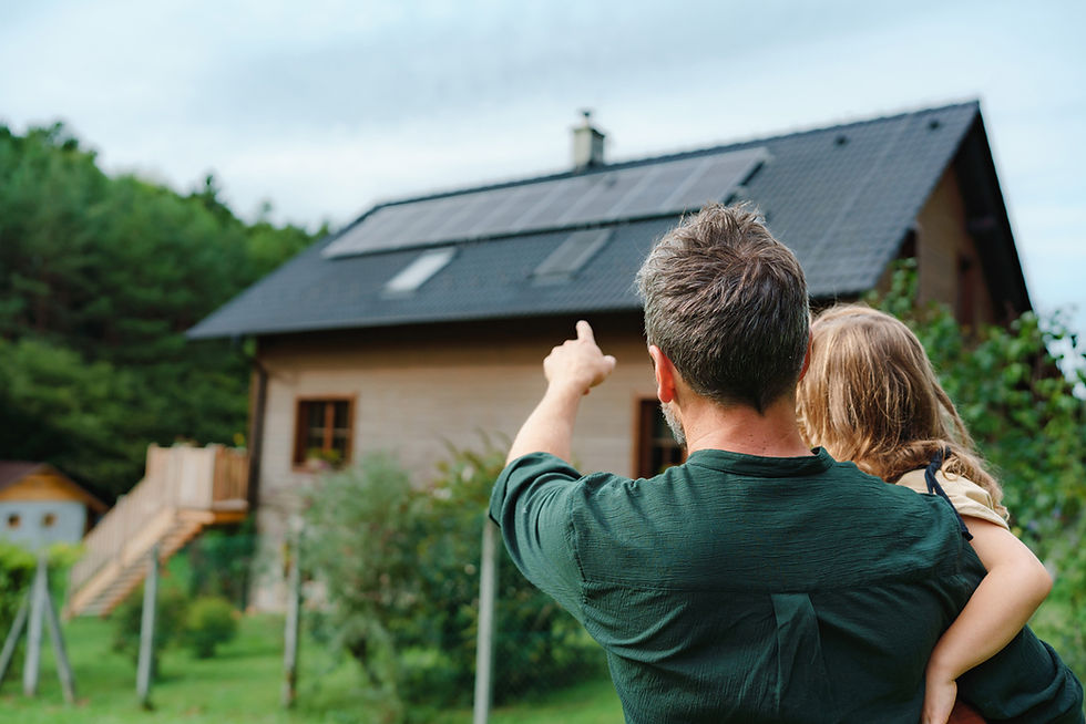 Parent with child pointing at solar panels on roof