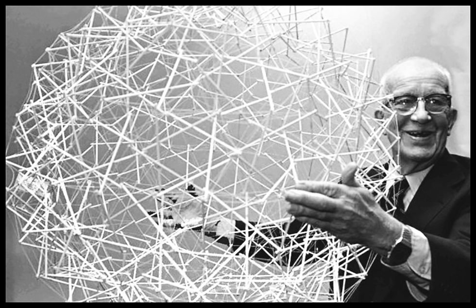 Buckminster Fuller holding a tensegrity sphere model.