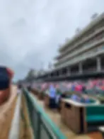 Vibrant view of the crowd at Churchill Downs during the Kentucky Derby, capturing the excitement and atmosphere from trackside, photographed by Dan Oshier Productions.