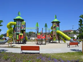 Large destination playground equipment with towers, rope bridges and tunnel slides