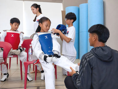 Young child learning Taekwondo in a kids martial arts class in Singapore