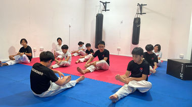 Teenagers having their Taekwondo training with Momentum in their Singapore's gym