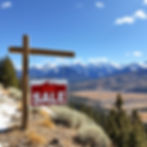 Real estate for sale sign in the mountains