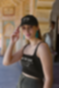 copy-of-dad-hat-and-tank-top-mockup-of-a-tattooed-woman-posing-in-a-historial-place-m34626