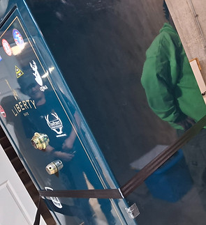 "Professional movers using heavy-duty equipment to transport a large high-security gun safe in a Kalamazoo home."