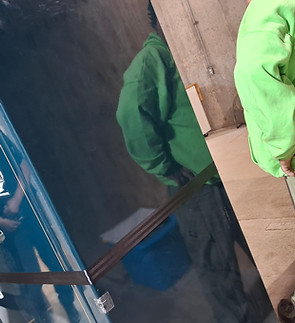 "Affordable Moving Kalamazoo specialists carefully navigating a heavy gun safe through a residential doorway."