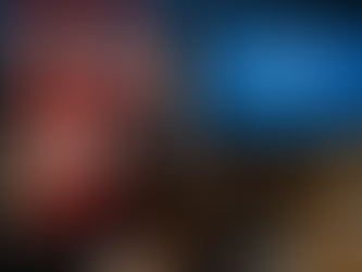 A realistic press-room photo in Ottawa: a middle-aged spokesperson at a podium with Canadian flags behind him addresses reporters about the Immigration Levels Plan 2026–2028. A screen beside the podium shows blurred bar charts; journalists with notebooks and cameras listen closely. Natural, candid expressions convey the seriousness of the policy announcement.