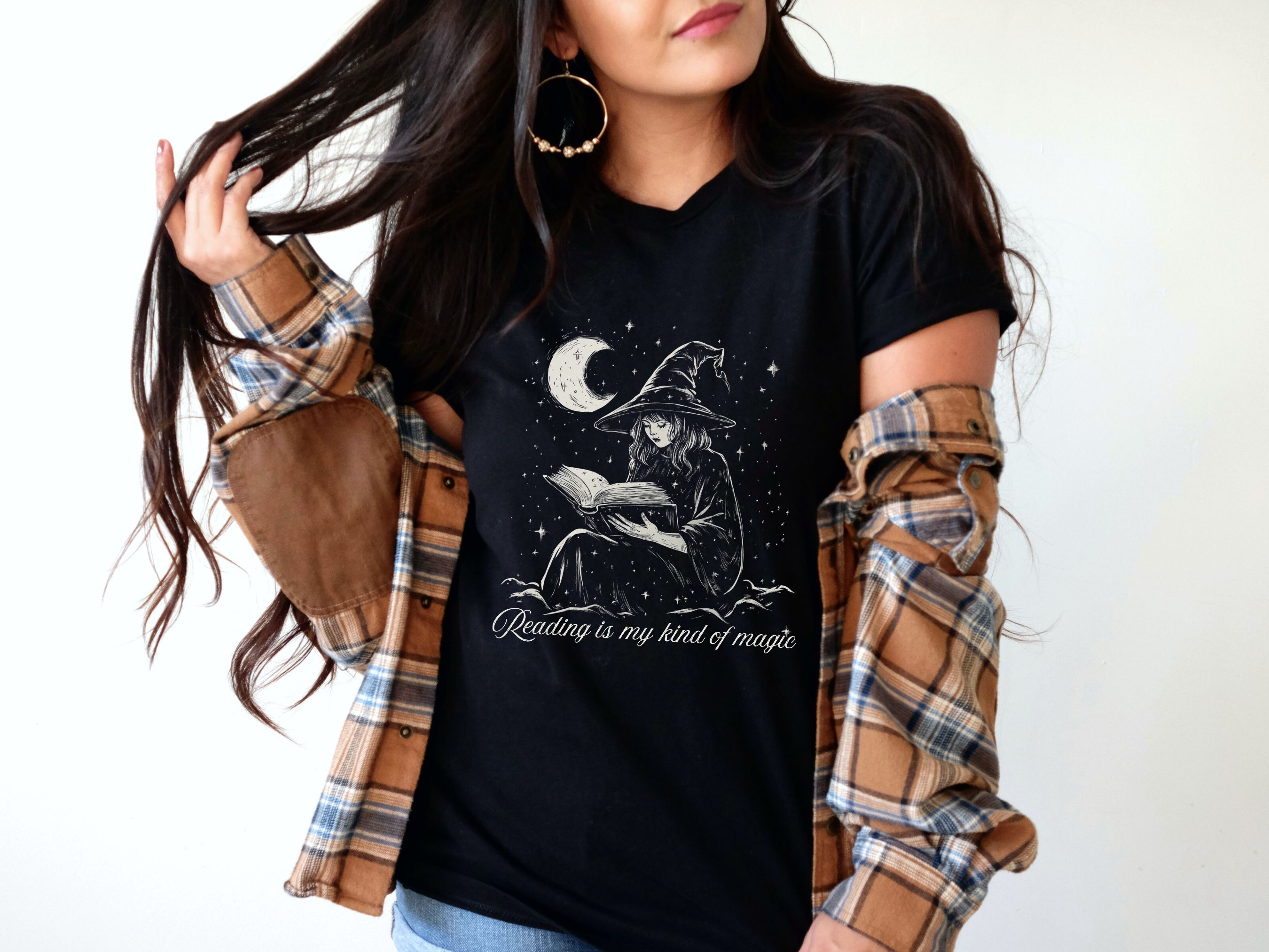 Black t-shirt with witch reading and the words "Reading is my kind of magic"