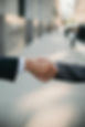 Photo of two people shaking hands that only shows the hands, wrist, and a little bit of the forearms.