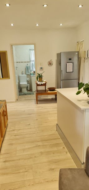 Interior view of a modern house, showing a kitchen and bathroom.