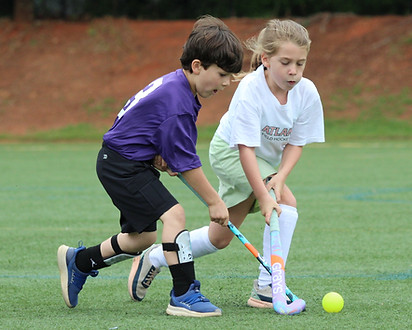 children playing field hockey