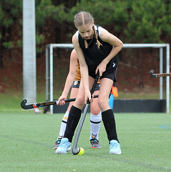 children playing field hockey