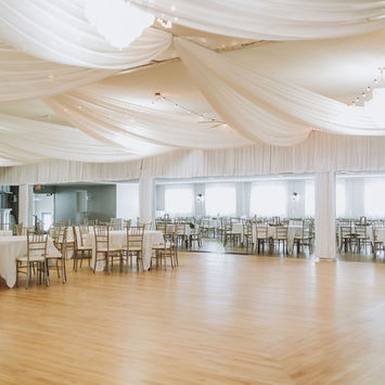Large reception hall with white ceiling draping