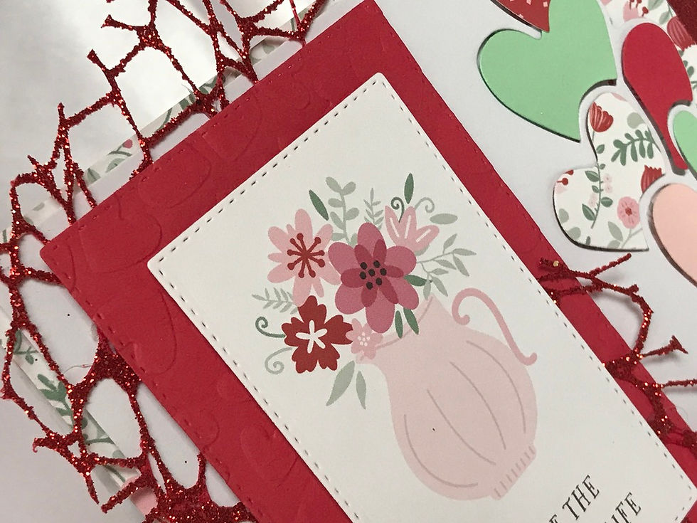 Thumbnail: Greeting card with floral vase, 'YOU ARE THE LOVE OF MY LIFE'.  A red, mint, and pink printed paper with floral theme is the background, with floating hearts in the same colors giving it a sweet vibe.  Red glittery mesh and ribbon give it some sparkle.