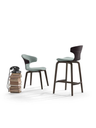 Montera stool by Poltrona Frau shown in a grouped arrangement with chairs emphasising its role within the collection