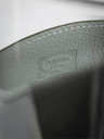Close-up of leather pot vase by Poltrona Frau showing textured surface and embossed branding detail